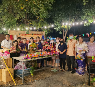 business administration students joining a sustainable community near the university making the  illuminating night full of music and green vessels made from banana leaves.